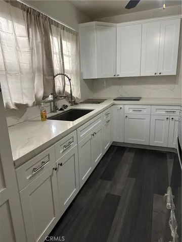 a kitchen with sink cabinets and window