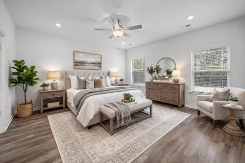 a bedroom with furniture and a large window