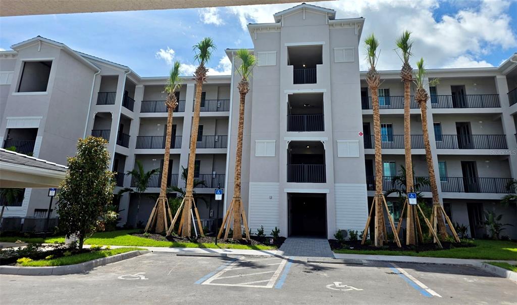 a front view of multi story residential apartment building with yard