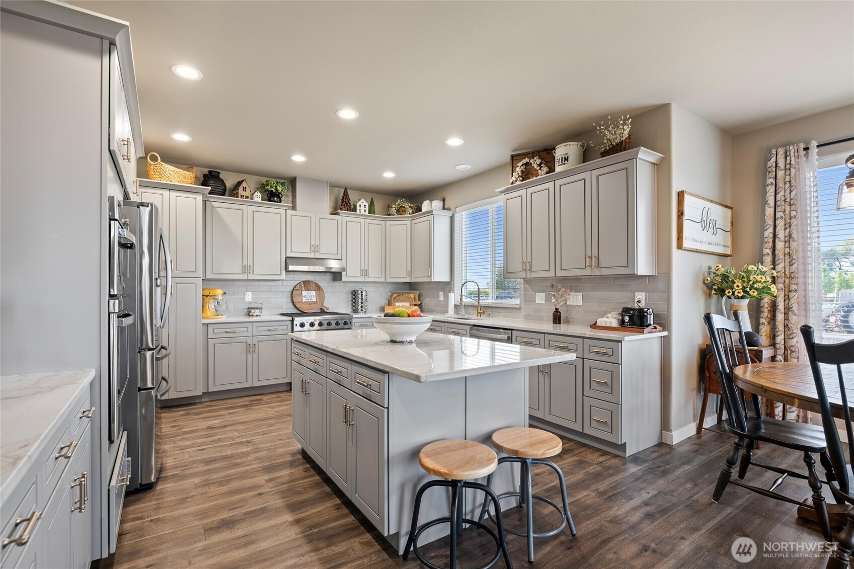 5889 Ne Road Moses Lake, WA 98837 - Photo 21 of 39 a kitchen with white cabinets and stainless steel appliances