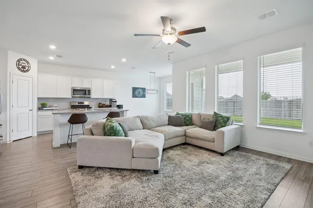 a living room with furniture and a large window