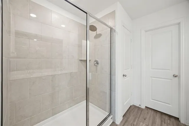 a bathroom with a glass shower door