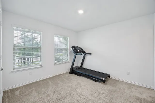 a room with gym equipment and windows