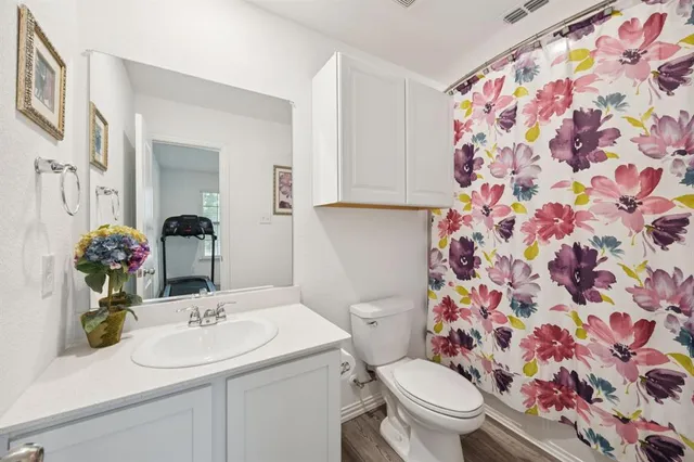 a bathroom with a sink and mirror with toilet