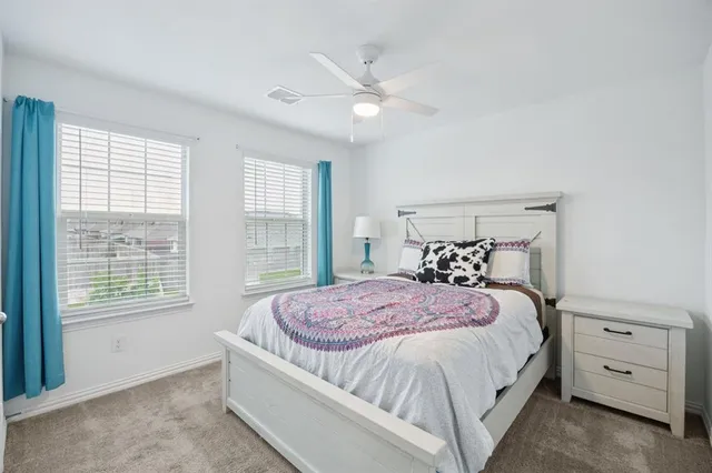 a bedroom with a large bed and a window