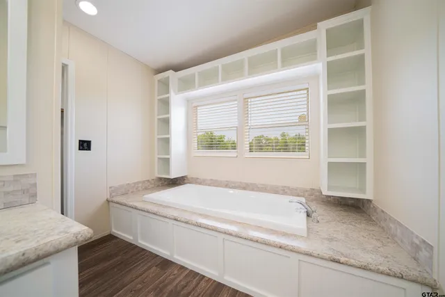 a bathroom with a sink double vanity granite and a mirror
