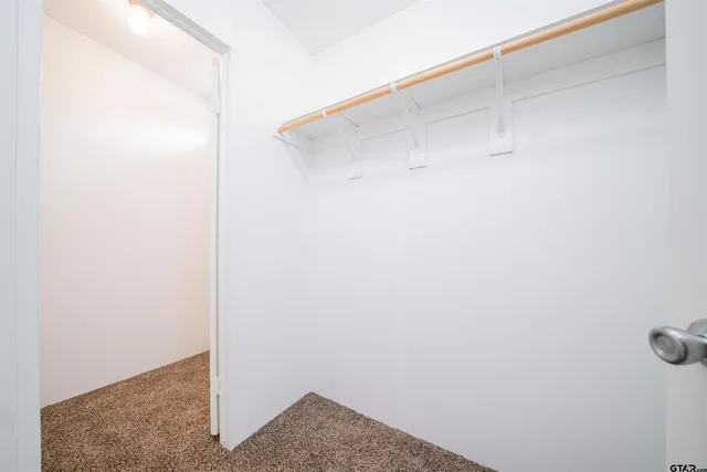 a view of a livingroom with a ceiling fan & window