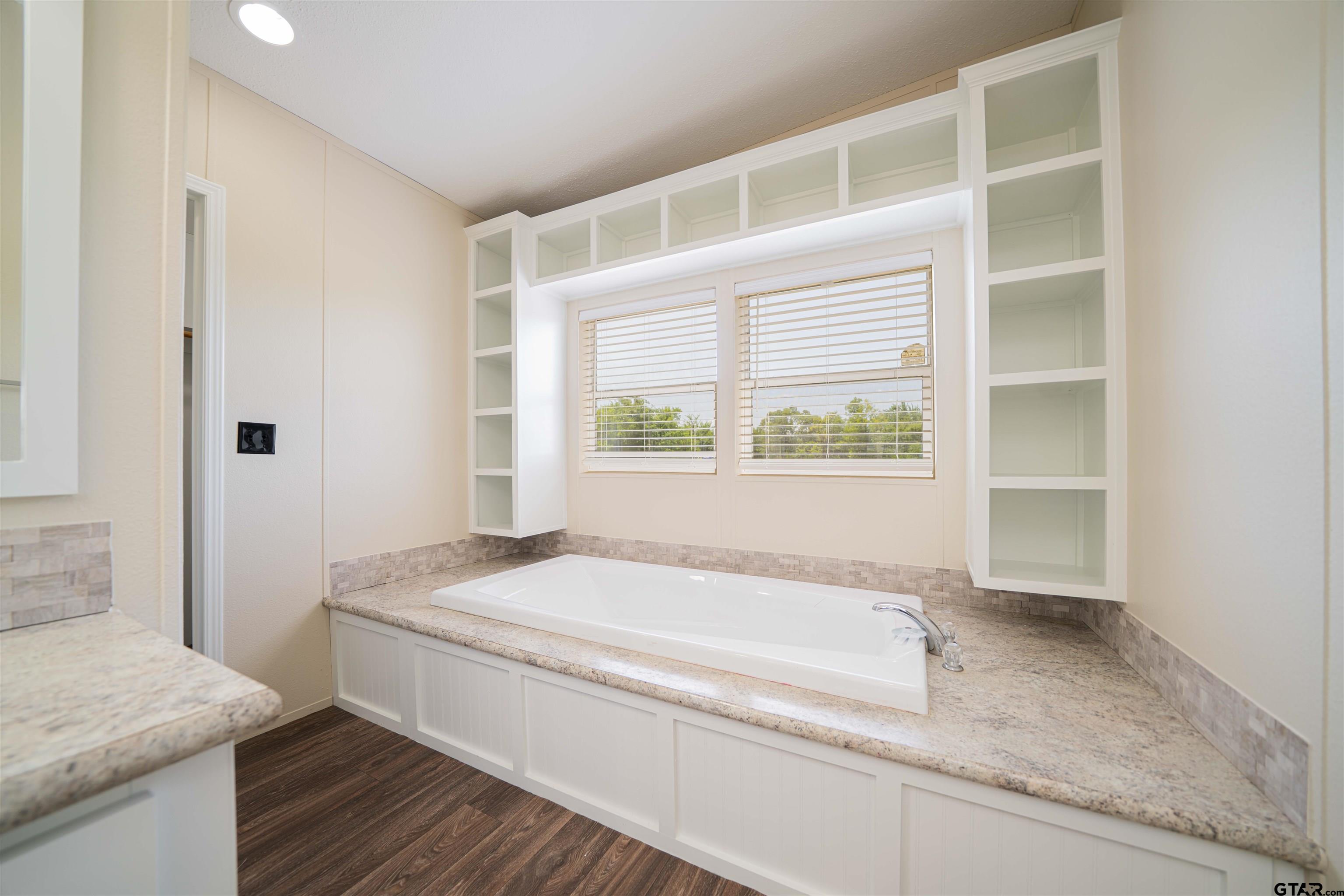 95 County Road 3565 Dike, TX 75437 - Photo 23 of 36 a bathroom with a granite countertop sink and a bathtub