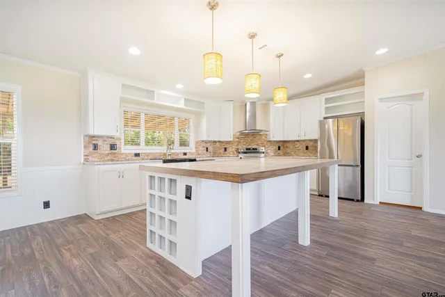 a kitchen with a wooden floor and window