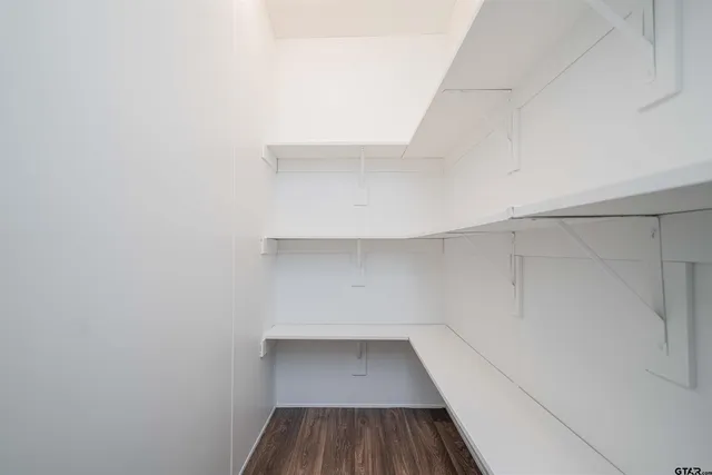 a view of a room with wooden floor