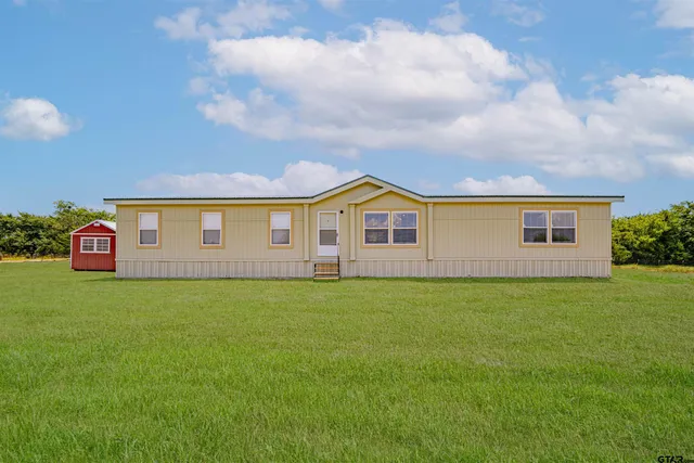 a view of swimming pool with a yard