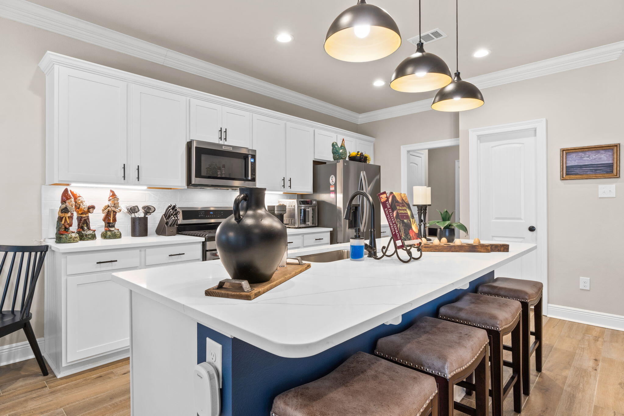 33 Cozy Cove Freeport, FL 32439 - Photo 11 of 87 a kitchen with a stove a microwave a dining table and chairs