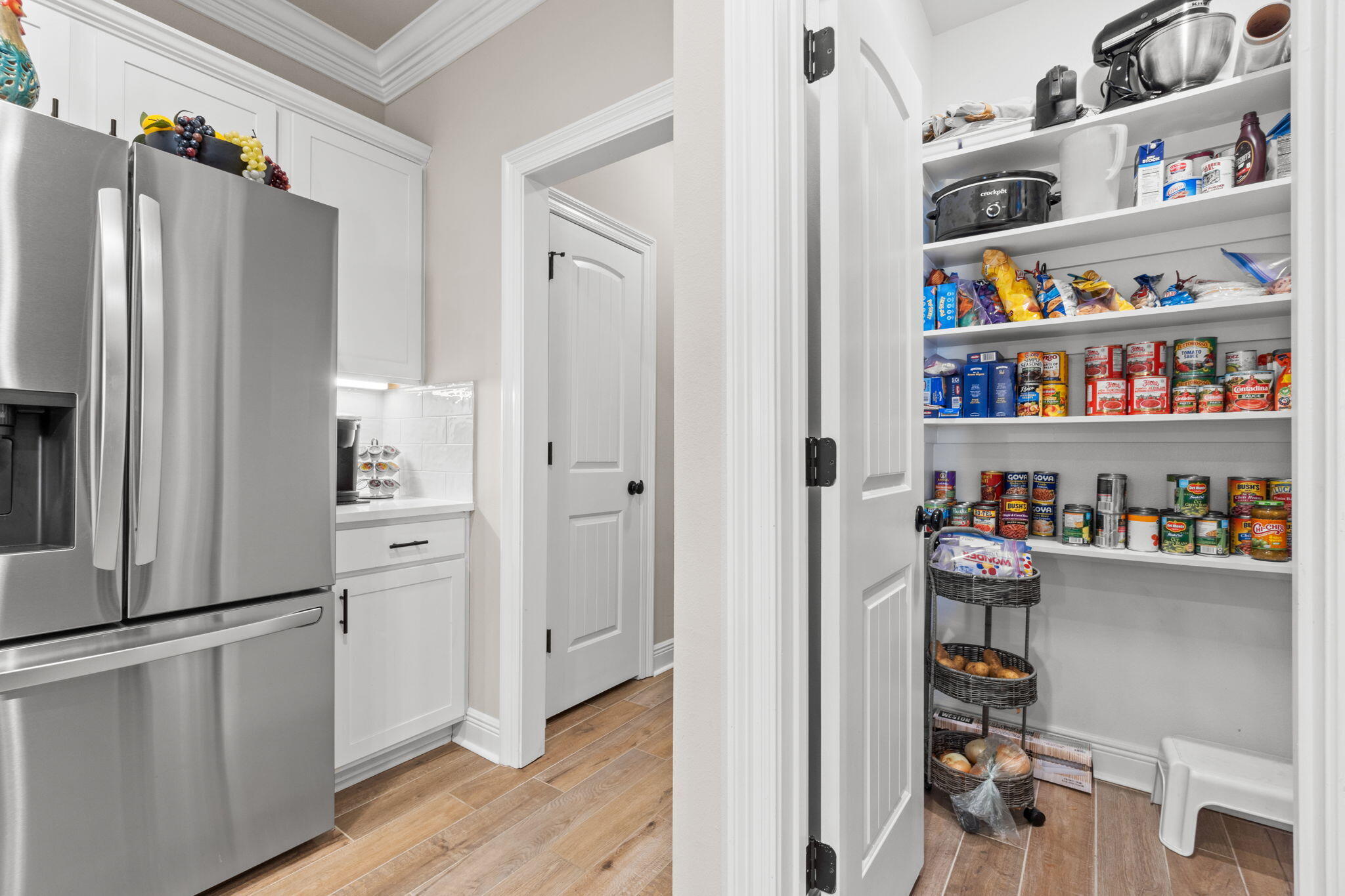 33 Cozy Cove Freeport, FL 32439 - Photo 19 of 87 a kitchen with stainless steel appliances a refrigerator and a wooden floor