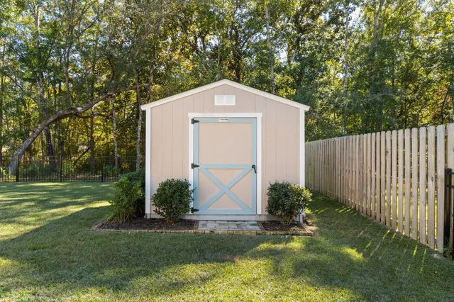 a view of a brick house with a small yard