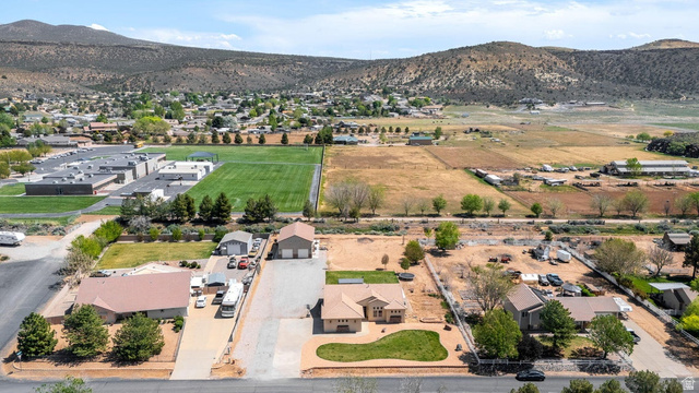 7776 Wagon Road East St. George, UT 84770 - Photo 71 of 76 Aerial perspective of suburban area featuring a mountain backdrop