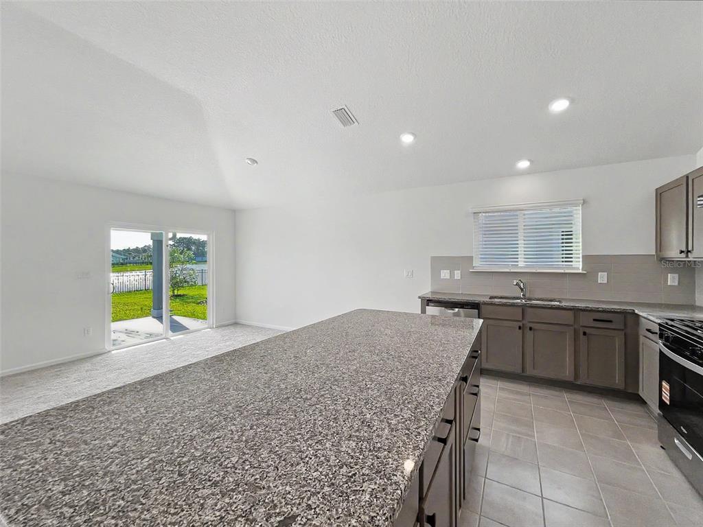 55 Signet Circle Flagler Beach, FL 32136 - Photo 24 of 39 a kitchen with a stove a sink and a refrigerator