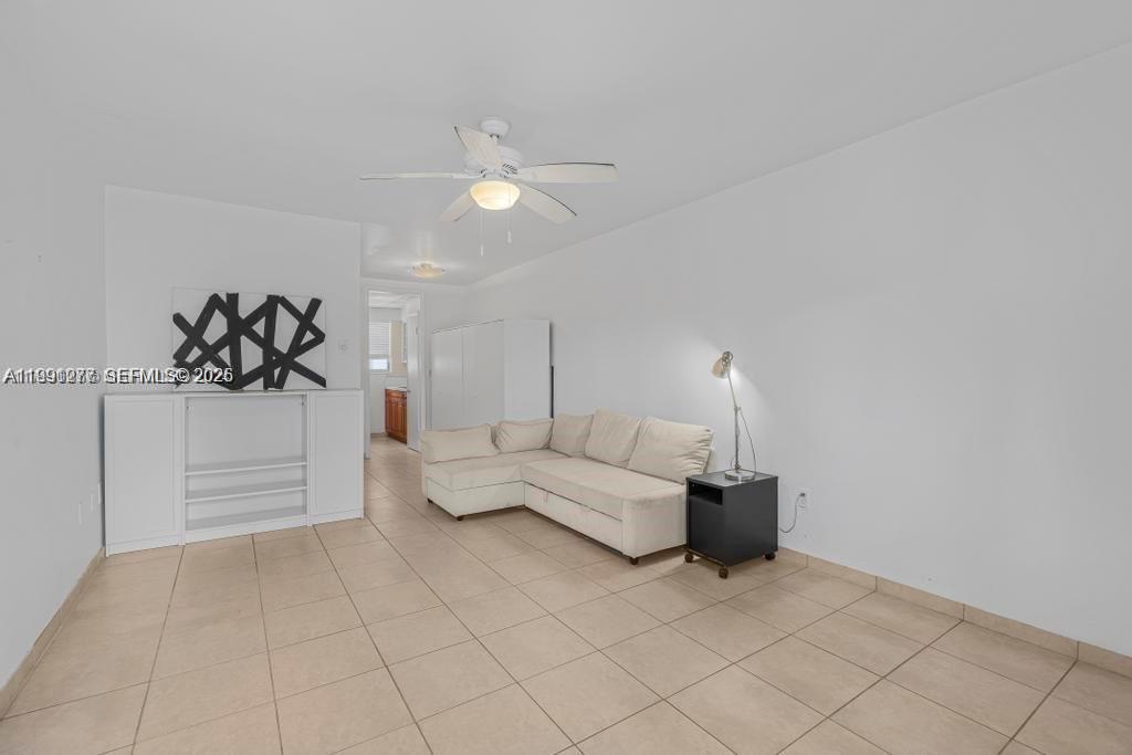 200 76th Street, Unit 59 Miami Beach, FL 33141 - Photo 4 of 16 a living room with furniture and white walls
