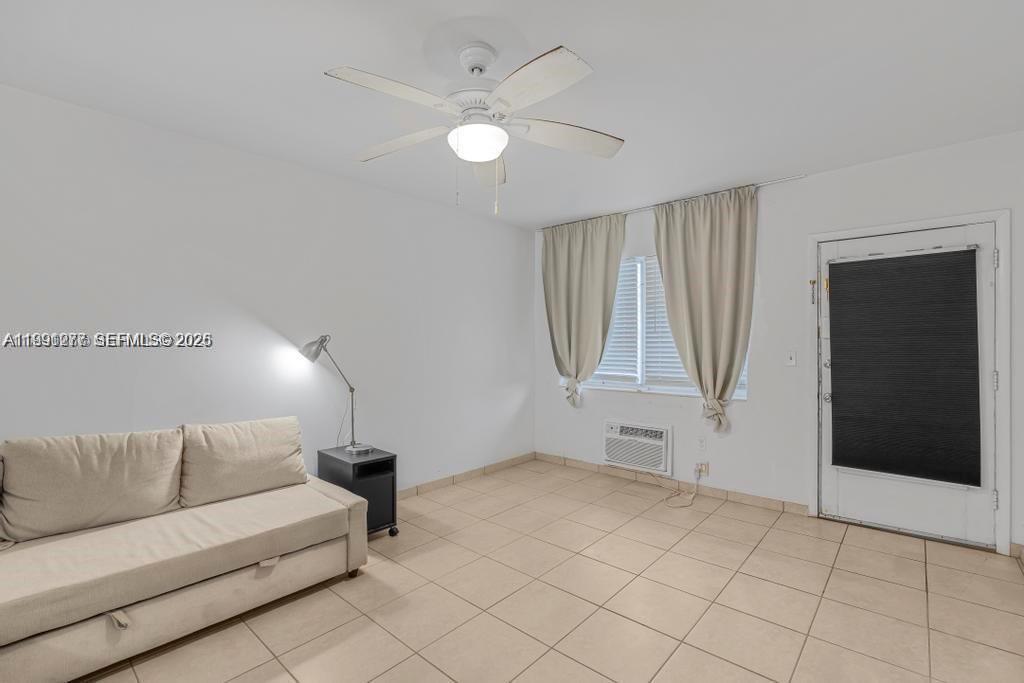 200 76th Street, Unit 59 Miami Beach, FL 33141 - Photo 5 of 16 a living room with furniture and a ceiling fan