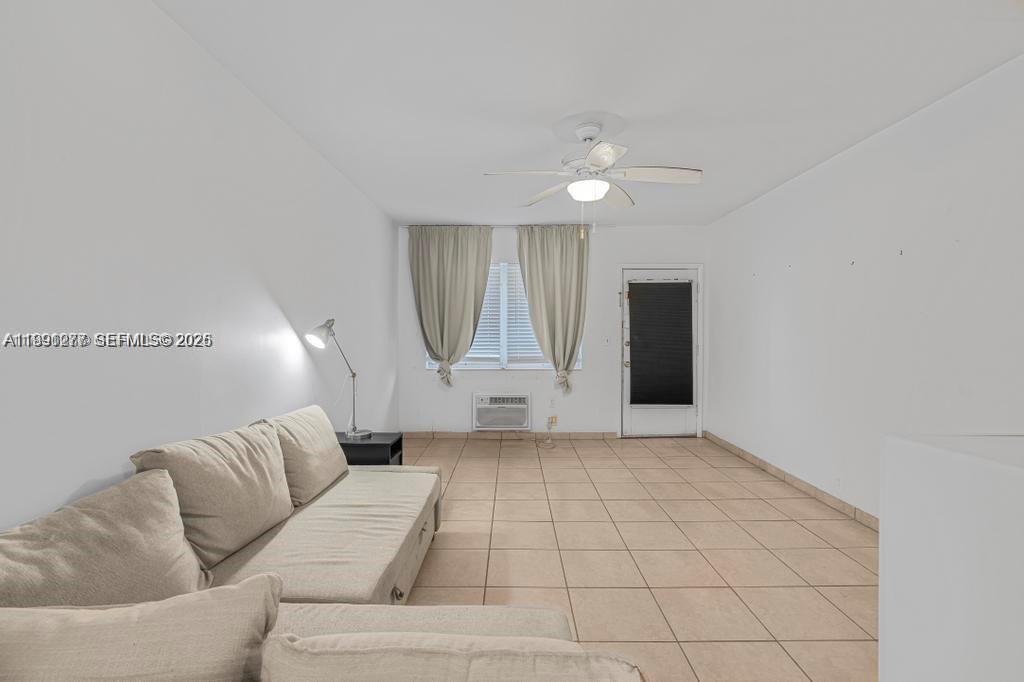 200 76th Street, Unit 59 Miami Beach, FL 33141 - Photo 6 of 16 a living room with furniture and a rug