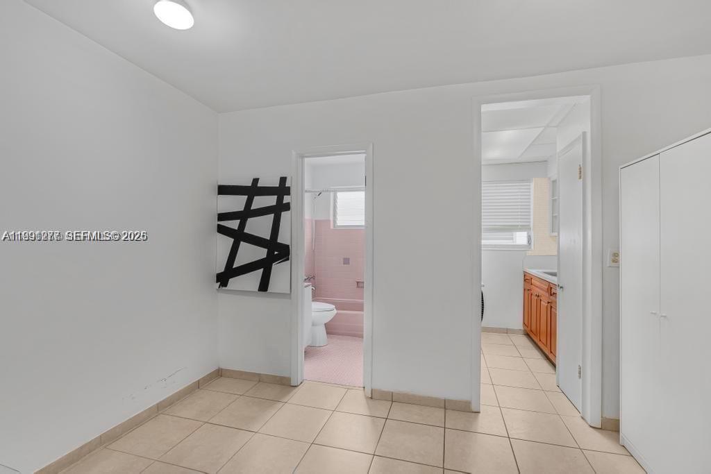 200 76th Street, Unit 59 Miami Beach, FL 33141 - Photo 7 of 16 a view of an entryway with wooden floor