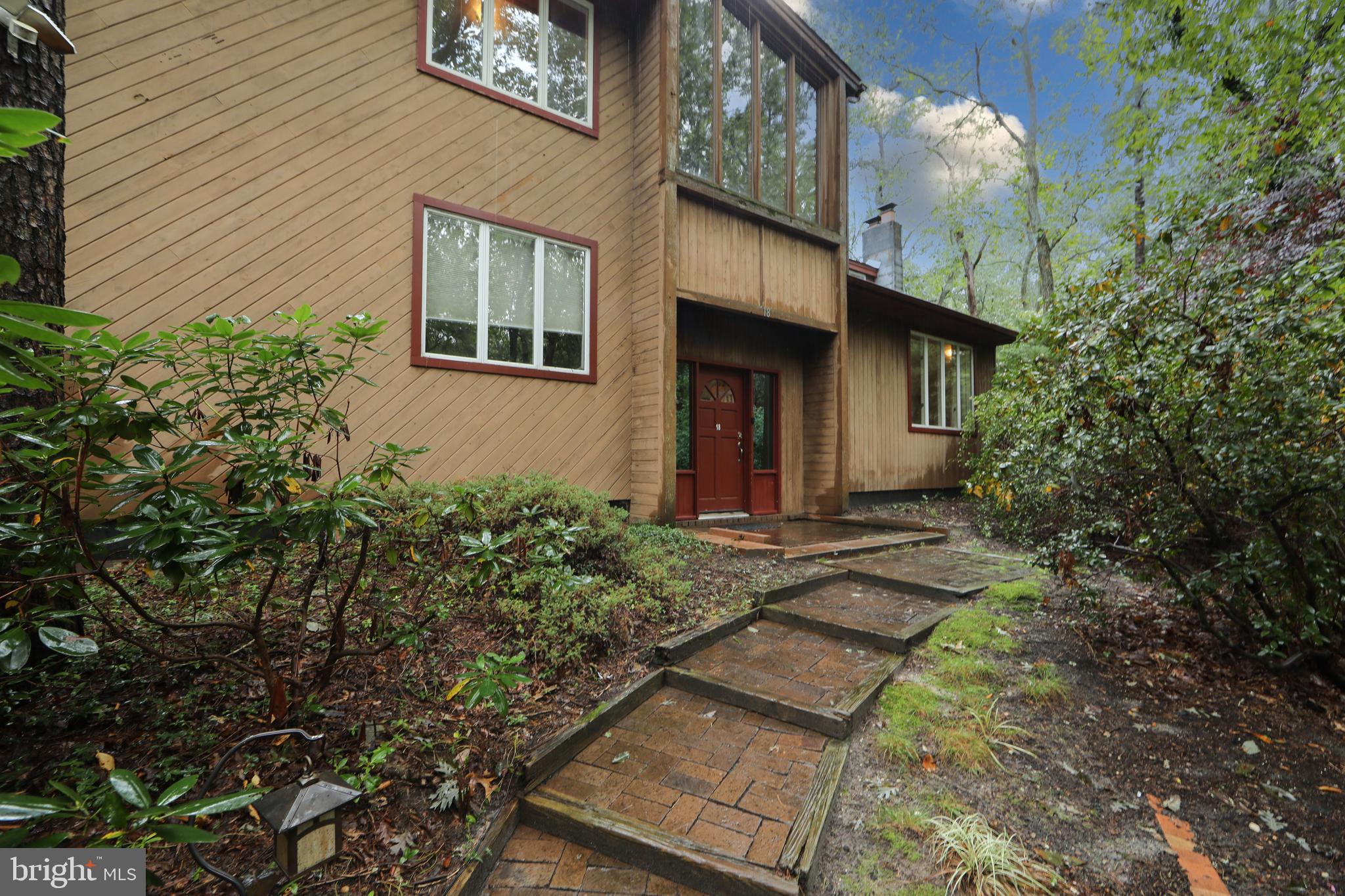 18 Tomahawk Court Medford, NJ 08055 - Photo 4 of 68 a view of a house with brick walls and potted plants