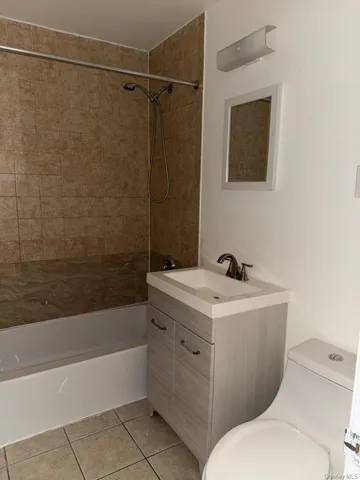 a white toilet sitting next to a bath tub
