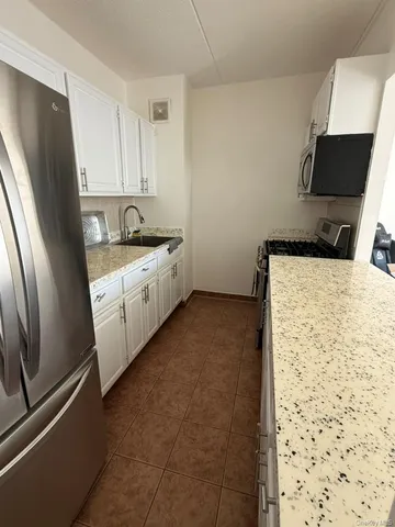 a kitchen with stainless steel appliances a refrigerator sink and stove