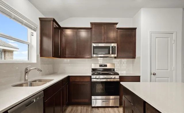 a kitchen with a refrigerator and a sink