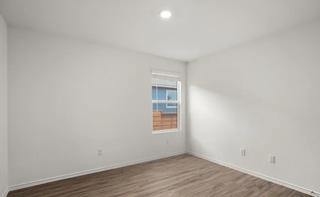 a view of kitchen island with wooden floor and window