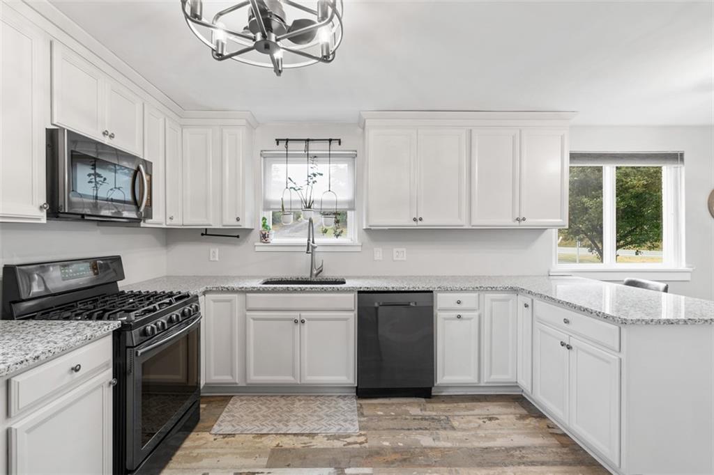 217 McMichael Road Carnegie, PA 15106 - Photo 14 of 38 a kitchen with stainless steel appliances granite countertop a stove a sink and a microwave