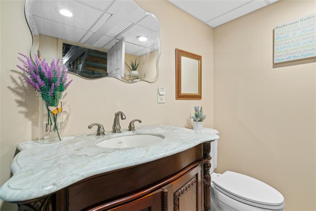 217 McMichael Road Carnegie, PA 15106 - Photo 27 of 38 a bathroom with a granite countertop sink a toilet and mirror