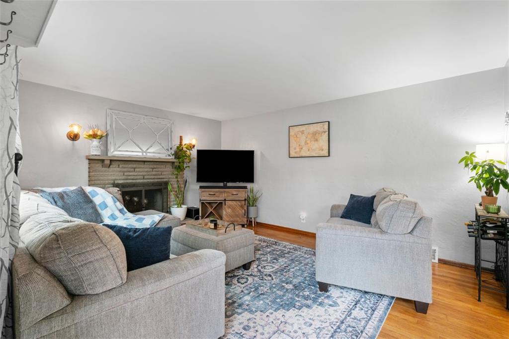 217 McMichael Road Carnegie, PA 15106 - Photo 7 of 38 a living room with furniture a flat screen tv and a fireplace