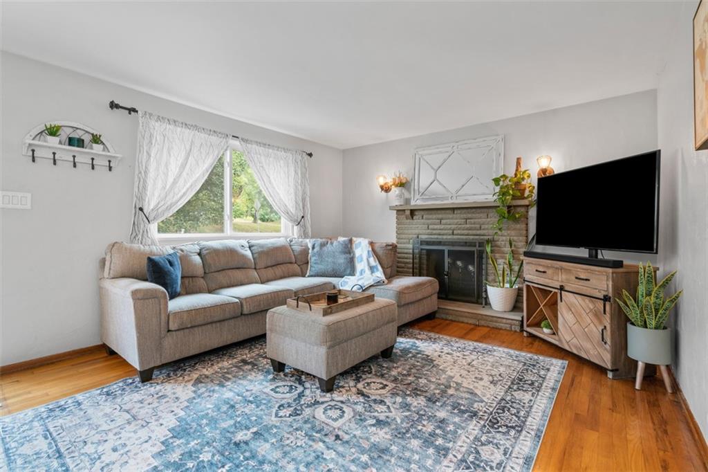 217 McMichael Road Carnegie, PA 15106 - Photo 8 of 38 a living room with furniture a flat screen tv and a fireplace