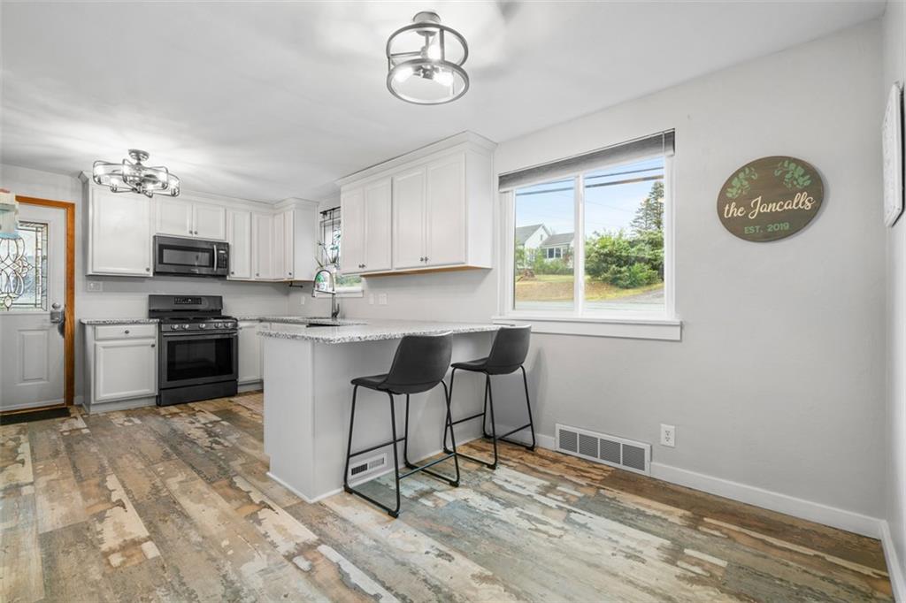 217 McMichael Road Carnegie, PA 15106 - Photo 10 of 38 a kitchen with a refrigerator cabinets and a window