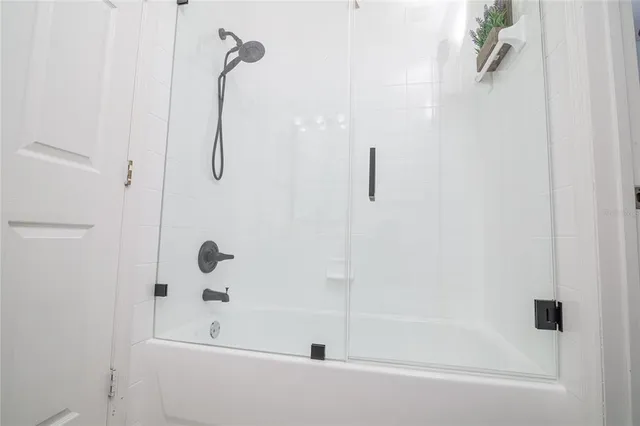 a bathroom with a bath tub with a shower