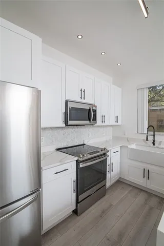 a close view of a sink and cabinets in kitchen