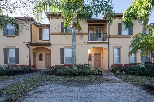 a front view of a house with yard and trees