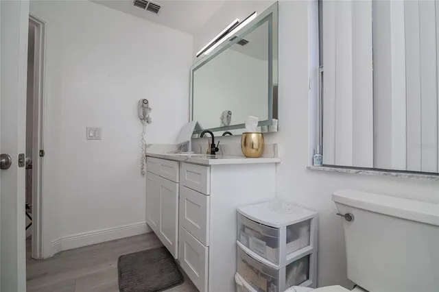 a room with a bed and a view of kitchen