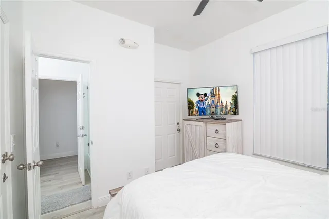 a bedroom with a bed and a flat screen tv