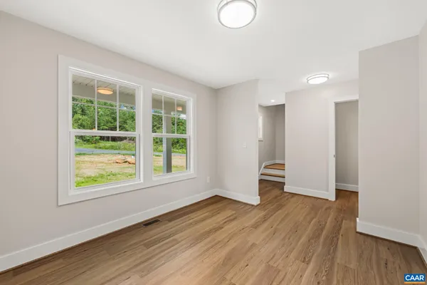 a view of a kitchen with a refrigerator and a stove top oven