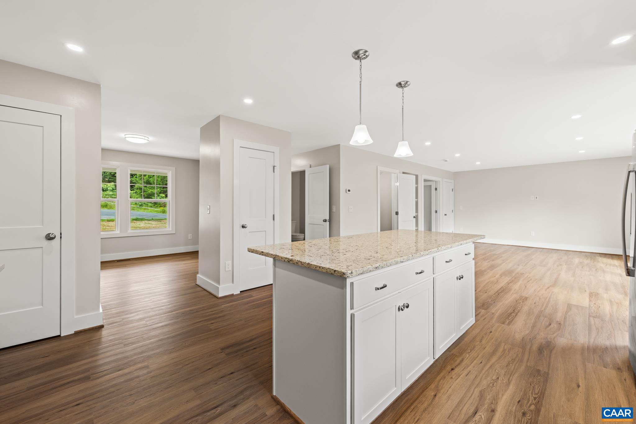 242 Palmer Place Ruckersville, VA 22968 - Photo 19 of 69 a large kitchen with a wooden floor and a ceiling fan