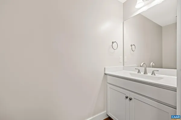 a view of a big room with windows and chandelier fan