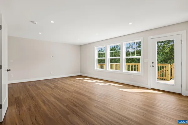 an empty room with a window and a ceiling fan