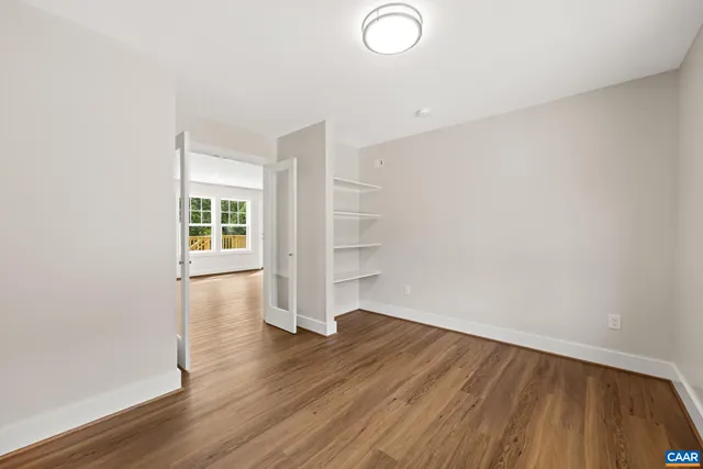 a spacious bedroom with a large bed and a potted plant