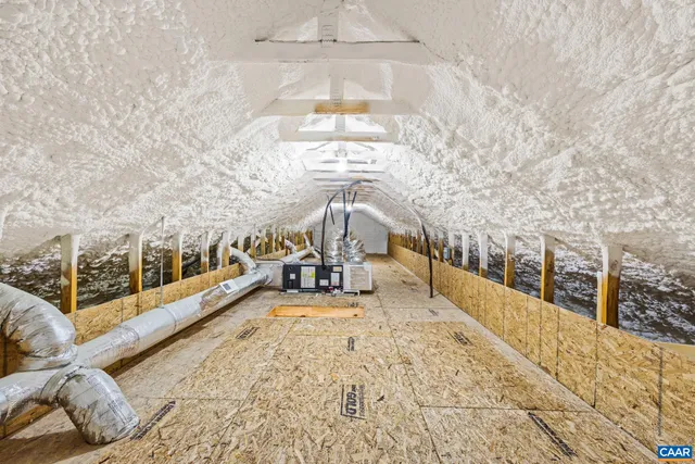 a view of a big room with windows and chandelier fan