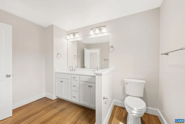 an empty room with closet and a hallway