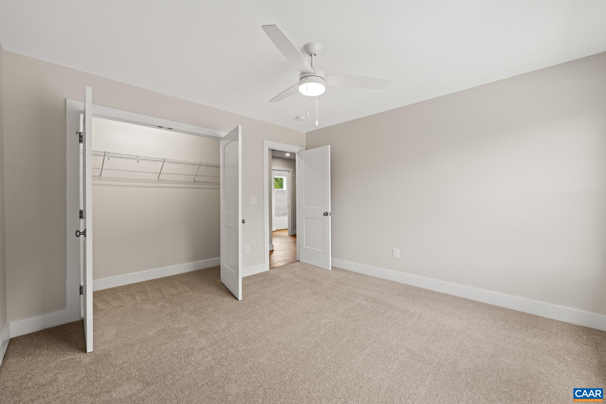242 Palmer Place Ruckersville, VA 22968 - Photo 45 of 69 an empty room with closet and a hallway