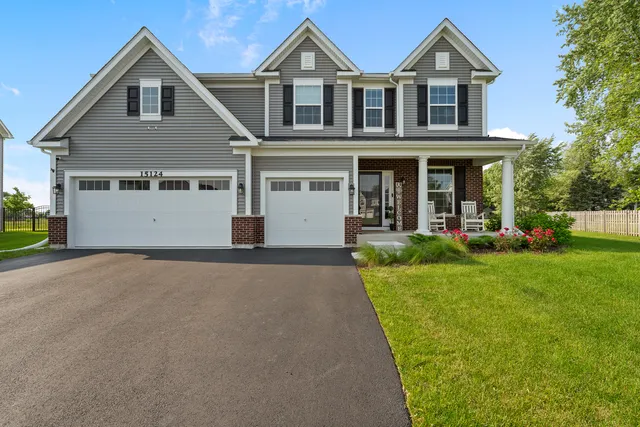 a front view of a house with a yard and garage