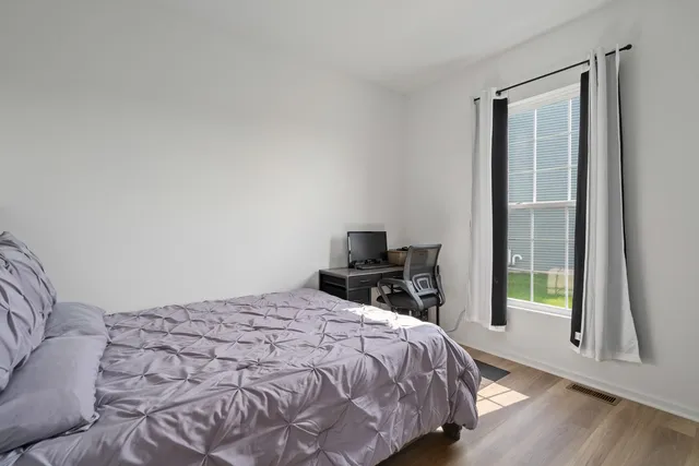 a bedroom with a bed and a window