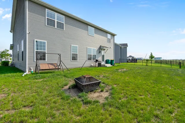 a backyard of a house with wooden floor and fence
